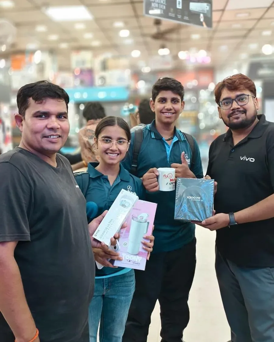 Mobile World team handing over a purchase to customers